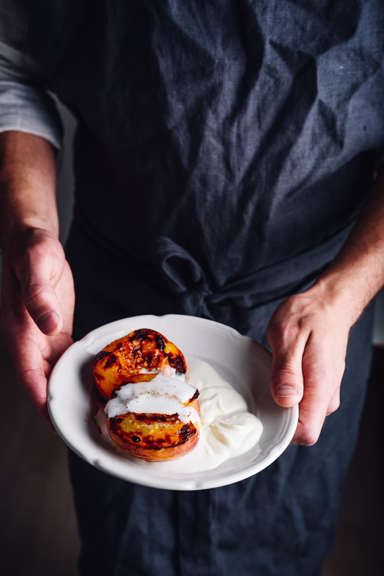 Artisan chef plating a modern dish on ceramic